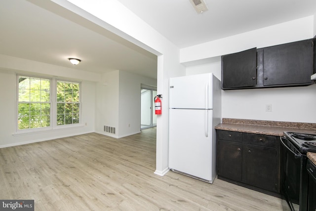 275 Green St Unit 4H5, Beverly, NJ 08010 - kitchen featuring freestanding refrigerator, black electric range oven, dark cabinetry, light wood-style floors, and baseboards