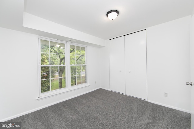 275 Green St Unit 4H5, Beverly, NJ 08010 - unfurnished bedroom with dark colored carpet, baseboards, and a closet