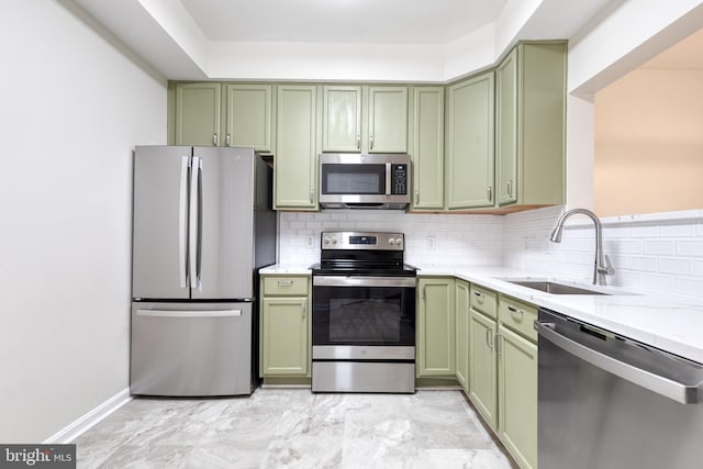 1915 Bulrush Ct, Odenton, MD 21113 - kitchen featuring green cabinetry, appliances with stainless steel finishes, a sink, backsplash, and light marble finish floors