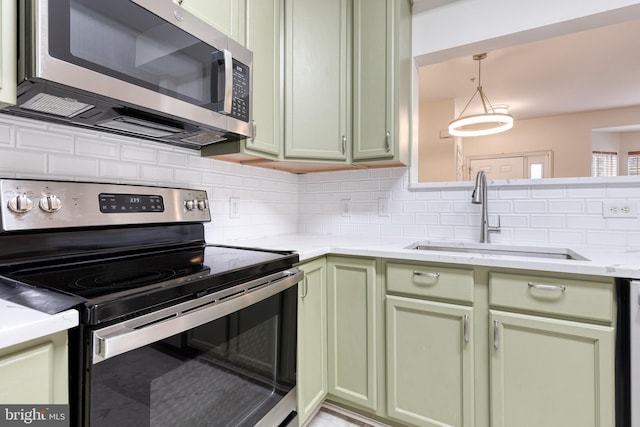 1915 Bulrush Ct, Odenton, MD 21113 - kitchen with appliances with stainless steel finishes, green cabinetry, a sink, decorative backsplash, and light countertops