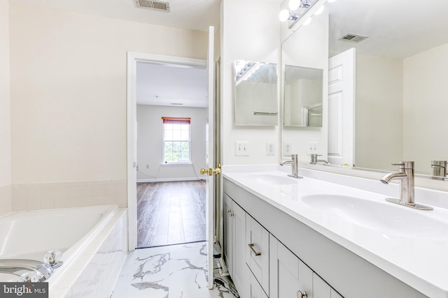 1915 Bulrush Ct, Odenton, MD 21113 - full bath featuring double vanity, a garden tub, and marble look tile flooring