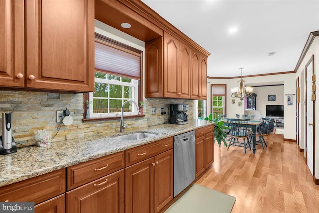 2332 Noel Cir, Pottstown, PA 19464 - kitchen with stainless steel dishwasher, a sink, brown cabinets, crown molding, and a chandelier