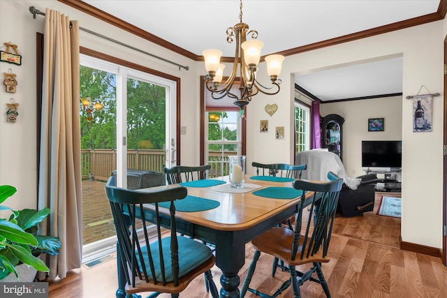 2332 Noel Cir, Pottstown, PA 19464 - dining room featuring wood finished floors, a chandelier, crown molding, and baseboards