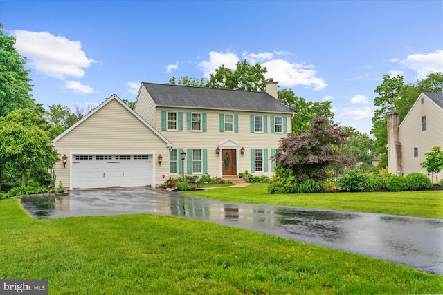 2332 Noel Cir, Pottstown, PA 19464 - colonial-style house with driveway, an attached garage, a chimney, and a front lawn
