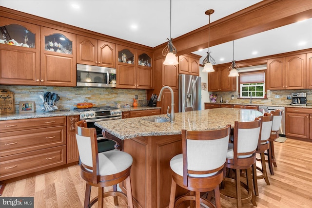 2332 Noel Cir, Pottstown, PA 19464 - kitchen with stainless steel appliances, a sink, brown cabinetry, light wood-style floors, and recessed lighting