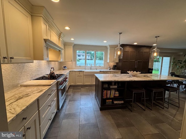 1041 Bobwhite Dr, Cherry Hill, NJ 08003 - kitchen with a sink, decorative backsplash, light stone countertops, a kitchen bar, and recessed lighting