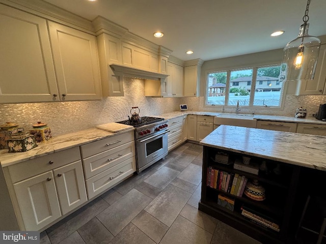 1041 Bobwhite Dr, Cherry Hill, NJ 08003 - kitchen with high end stainless steel range oven, a sink, backsplash, white cabinets, and light stone counters