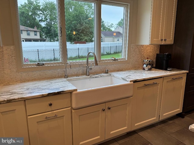 1041 Bobwhite Dr, Cherry Hill, NJ 08003 - kitchen with a sink, tasteful backsplash, white cabinetry, dark tile patterned floors, and light stone countertops