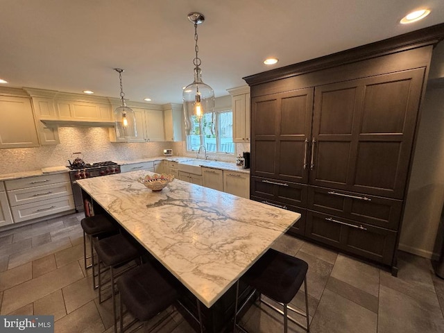 1041 Bobwhite Dr, Cherry Hill, NJ 08003 - kitchen featuring tasteful backsplash, a kitchen bar, a sink, recessed lighting, and high end range