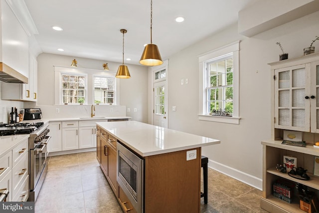 4405 Underwood Rd, Baltimore, MD 21218 - kitchen with stainless steel appliances, a center island, recessed lighting, premium range hood, and light countertops