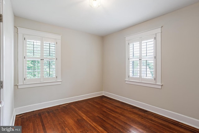 4405 Underwood Rd, Baltimore, MD 21218 - spare room featuring plenty of natural light, baseboards, and dark wood finished floors
