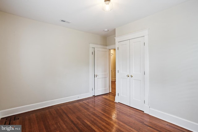 4405 Underwood Rd, Baltimore, MD 21218 - unfurnished bedroom with baseboards, wood finished floors, and a closet