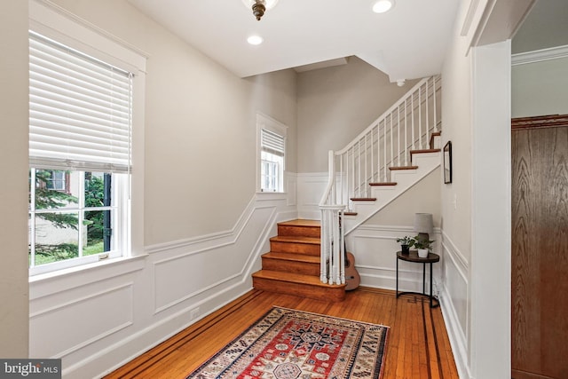 4405 Underwood Rd, Baltimore, MD 21218 - foyer with a decorative wall, plenty of natural light, stairway, wainscoting, and hardwood / wood-style floors