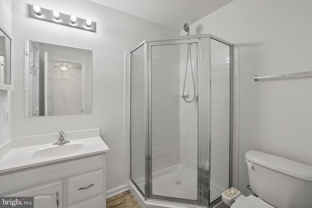 44138 Allderwood Ter, Ashburn, VA 20147 - full bathroom with toilet, vanity, a shower stall, and wood finished floors