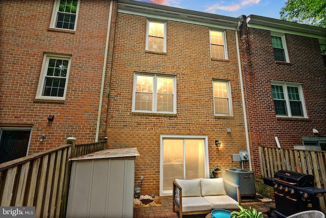 2455 Alsop Ct, Reston, VA 20191 - rear view of house with brick siding, an outdoor living space, and central air condition unit
