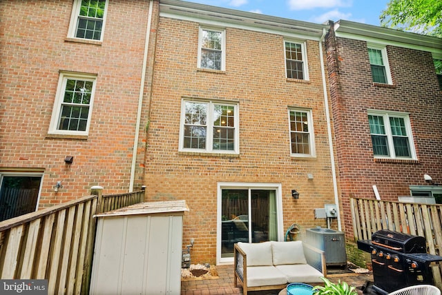 2455 Alsop Ct, Reston, VA 20191 - back of house featuring brick siding, central AC, an outdoor living space, and a shed