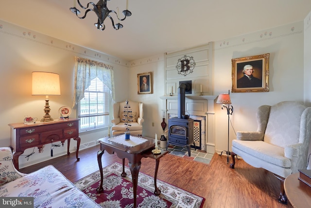 2 Kings Ct, Gordonville, PA 17529 - living area featuring a wood stove, wood finished floors, a chandelier, and baseboards