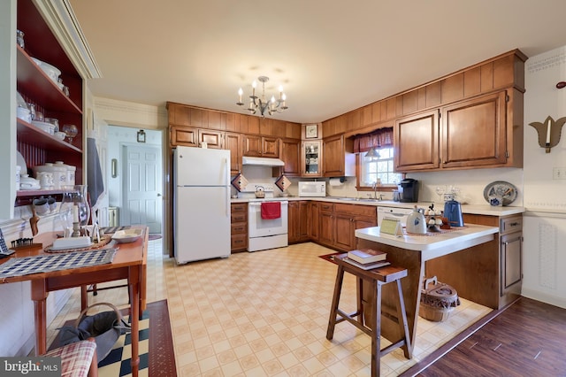 2 Kings Ct, Gordonville, PA 17529 - kitchen with white appliances, under cabinet range hood, a chandelier, brown cabinets, and light countertops