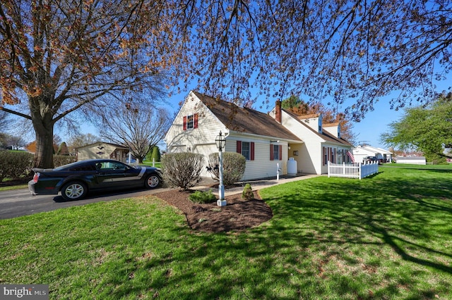 2 Kings Ct, Gordonville, PA 17529 - view of side of home featuring a garage, driveway, a lawn, and a chimney