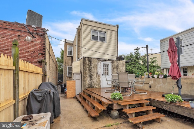 2609 E Monmouth St, Philadelphia, PA 19134 - rear view of house featuring a wooden deck and outdoor dining area