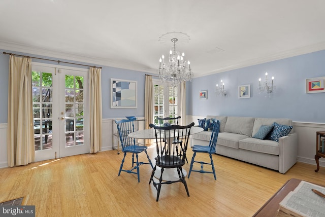 116 Cameron Mews, Alexandria, VA 22314 - dining room with a chandelier, wood finished floors, ornamental molding, french doors, and wainscoting