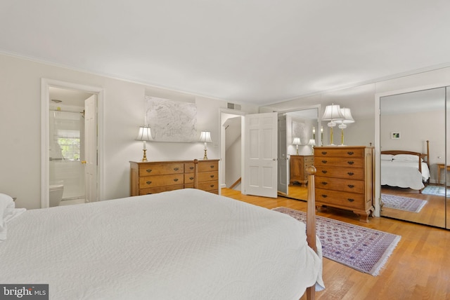 116 Cameron Mews, Alexandria, VA 22314 - bedroom featuring light wood-style floors, ensuite bathroom, and ornamental molding