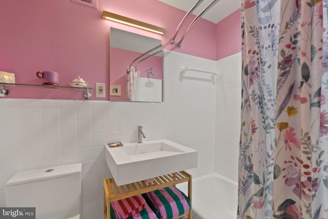 116 Cameron Mews, Alexandria, VA 22314 - bathroom with shower / bath combo with shower curtain, toilet, and tile walls