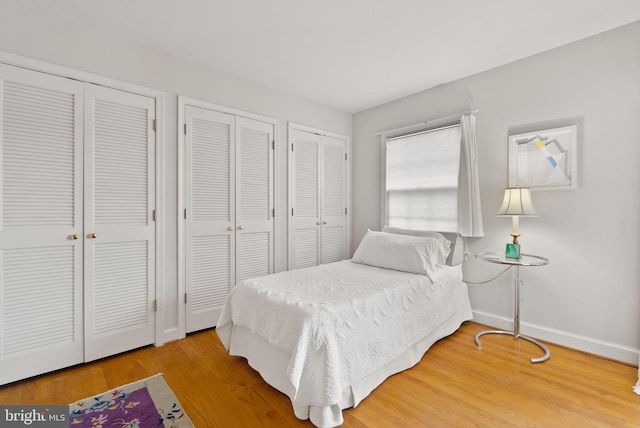 116 Cameron Mews, Alexandria, VA 22314 - bedroom featuring two closets, wood finished floors, and baseboards