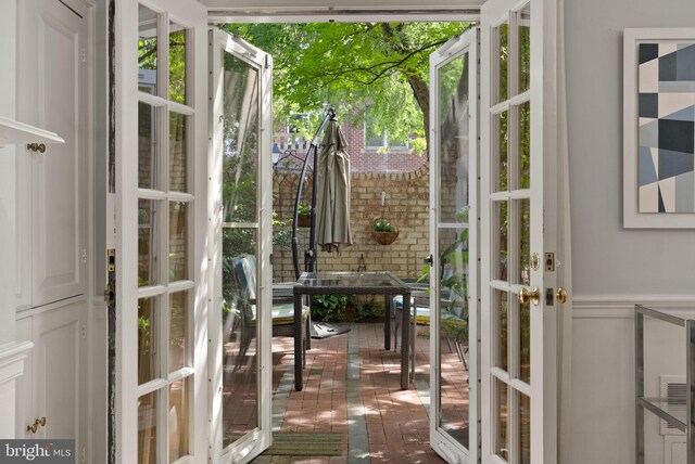 116 Cameron Mews, Alexandria, VA 22314 - entryway featuring french doors, brick flooring, and wainscoting