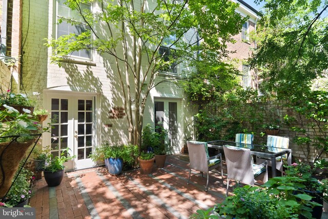116 Cameron Mews, Alexandria, VA 22314 - view of patio with french doors, outdoor dining area, and a deck