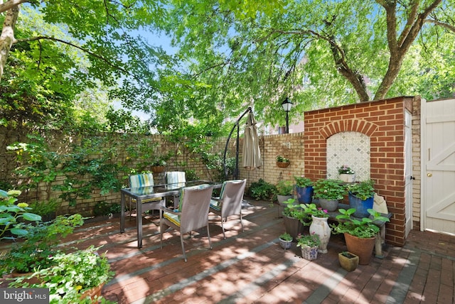 116 Cameron Mews, Alexandria, VA 22314 - fenced backyard with outdoor dining space and a wooden deck