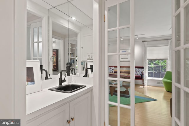 116 Cameron Mews, Alexandria, VA 22314 - bar area featuring a sink and light wood-style floors