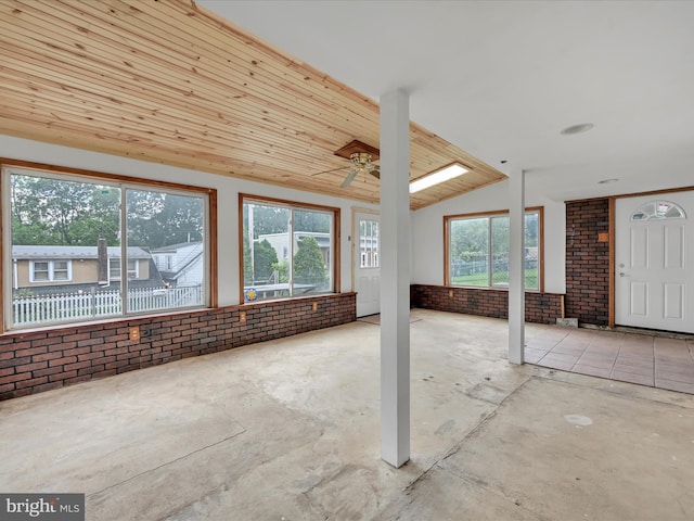 9 S Stanton St, Schuylkill Haven, PA 17972 - unfurnished living room featuring brick wall, ceiling fan, wood ceiling, vaulted ceiling, and unfinished concrete flooring
