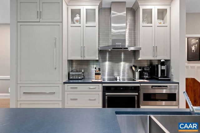 15 Trillium Close, Wintergreen Resort, VA 22967 - kitchen with black appliances, wall chimney range hood, decorative backsplash, and glass insert cabinets