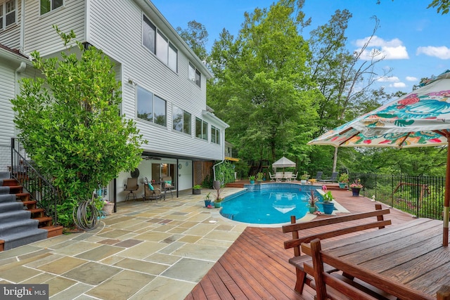 10200 Souza Ln, Manassas, VA 20111 - view of pool with stairway, a wooden deck, and a patio area