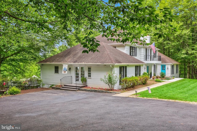 10200 Souza Ln, Manassas, VA 20111 - view of front of property with a shingled roof, a balcony, a chimney, and a front lawn