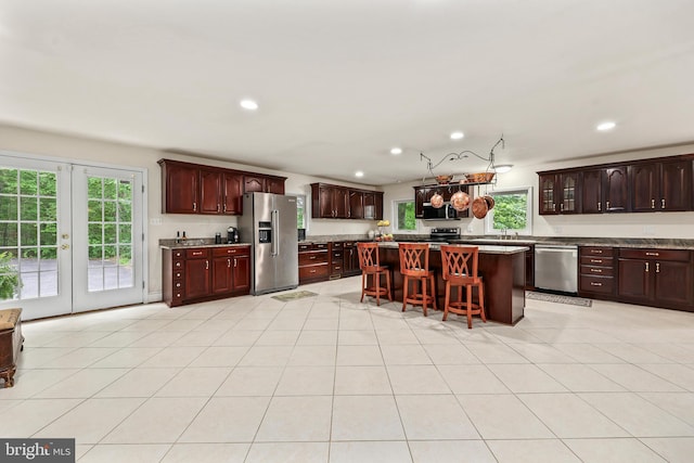 10200 Souza Ln, Manassas, VA 20111 - kitchen with stainless steel appliances, a kitchen bar, plenty of natural light, a center island, and recessed lighting