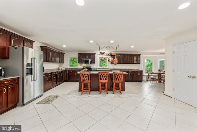 10200 Souza Ln, Manassas, VA 20111 - kitchen featuring stainless steel appliances, a center island, recessed lighting, a kitchen breakfast bar, and light tile patterned floors