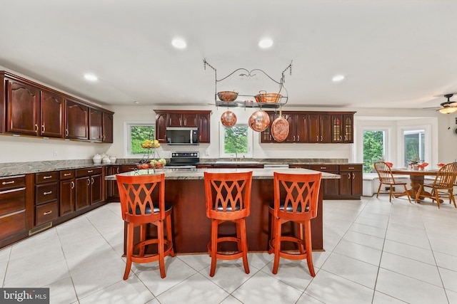 10200 Souza Ln, Manassas, VA 20111 - kitchen featuring stainless steel appliances, a center island, healthy amount of natural light, a sink, and recessed lighting