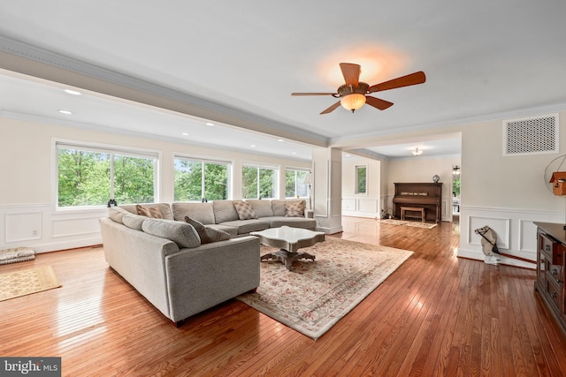 10200 Souza Ln, Manassas, VA 20111 - living area featuring a decorative wall, crown molding, hardwood / wood-style flooring, wainscoting, and ceiling fan