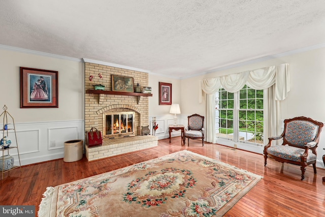 10200 Souza Ln, Manassas, VA 20111 - living room with a textured ceiling, hardwood / wood-style flooring, crown molding, and a fireplace