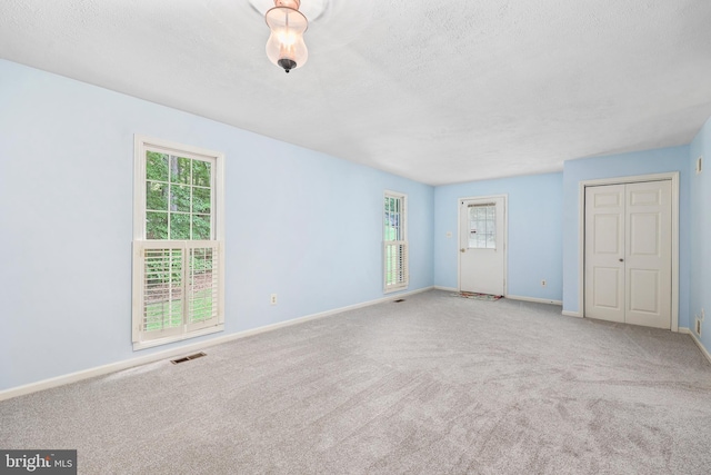 10200 Souza Ln, Manassas, VA 20111 - unfurnished bedroom featuring multiple windows, carpet flooring, baseboards, and a textured ceiling