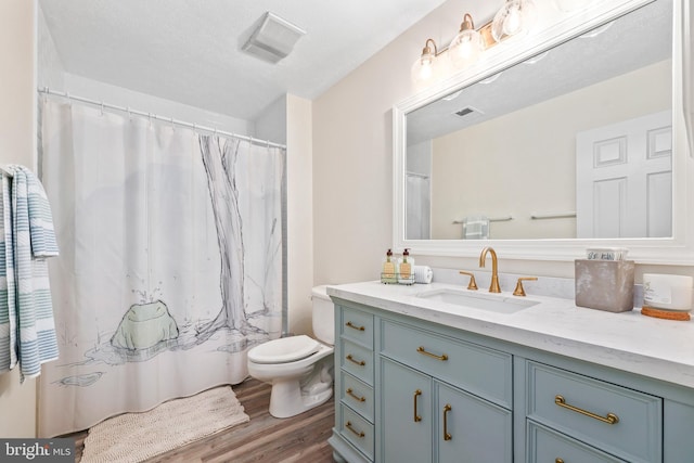 10200 Souza Ln, Manassas, VA 20111 - bathroom featuring vanity, wood finished floors, and toilet