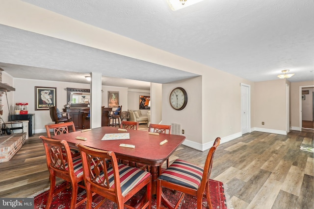 10200 Souza Ln, Manassas, VA 20111 - dining space featuring wood finished floors, baseboards, and a textured ceiling