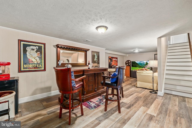 10200 Souza Ln, Manassas, VA 20111 - indoor wet bar with baseboards, wood finished floors, stairs, and a textured ceiling