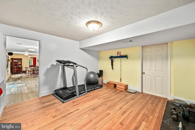 10200 Souza Ln, Manassas, VA 20111 - workout room featuring hardwood / wood-style flooring, a textured ceiling, and baseboards