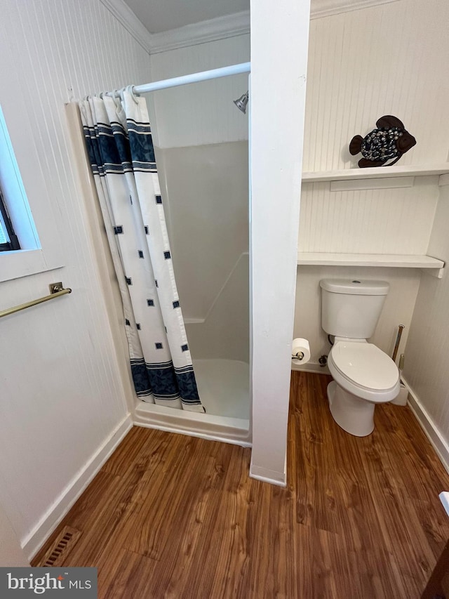 23 Beaconhill Rd, Ocean Pines, MD 21811 - full bath with wood finished floors, a stall shower, toilet, crown molding, and baseboards