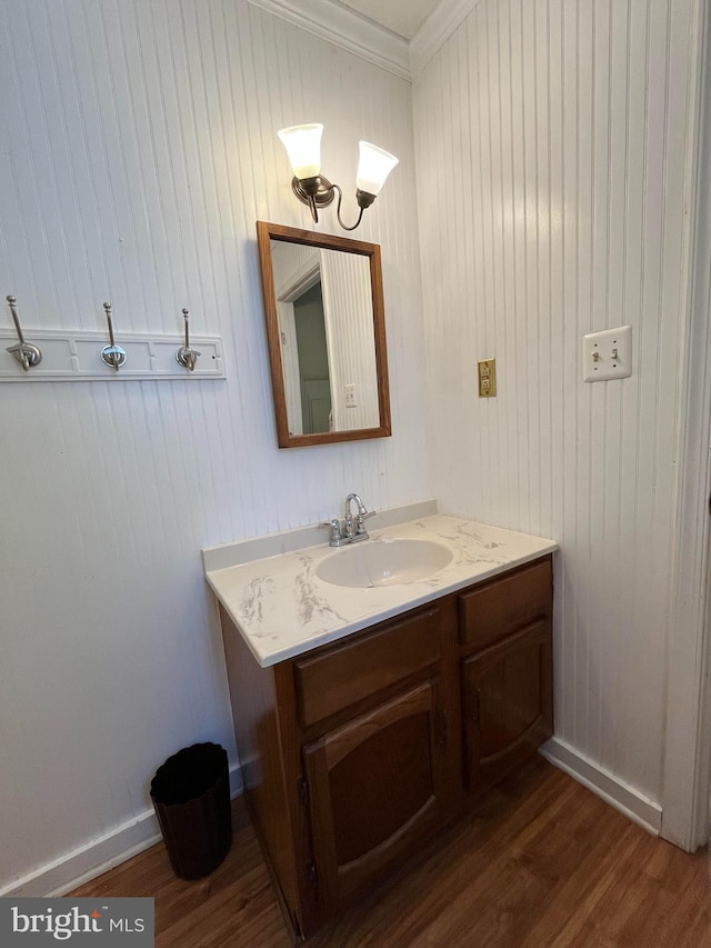 23 Beaconhill Rd, Ocean Pines, MD 21811 - bathroom featuring crown molding, vanity, wood finished floors, and baseboards
