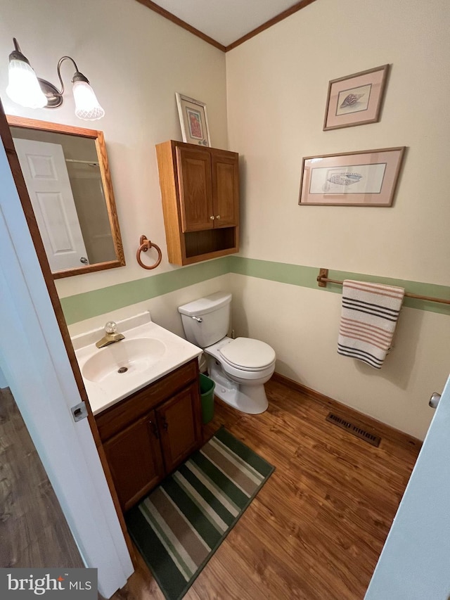 23 Beaconhill Rd, Ocean Pines, MD 21811 - bathroom with wood finished floors, vanity, crown molding, and toilet