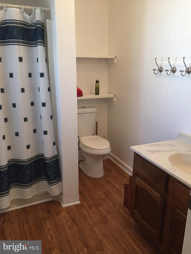 23 Beaconhill Rd, Ocean Pines, MD 21811 - bathroom with wood finished floors, vanity, toilet, baseboards, and a shower with curtain